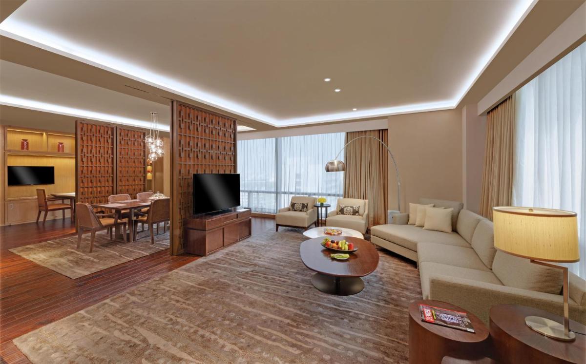 a living room with a couch and a table at Hyatt Regency Ahmedabad in Ahmedabad
