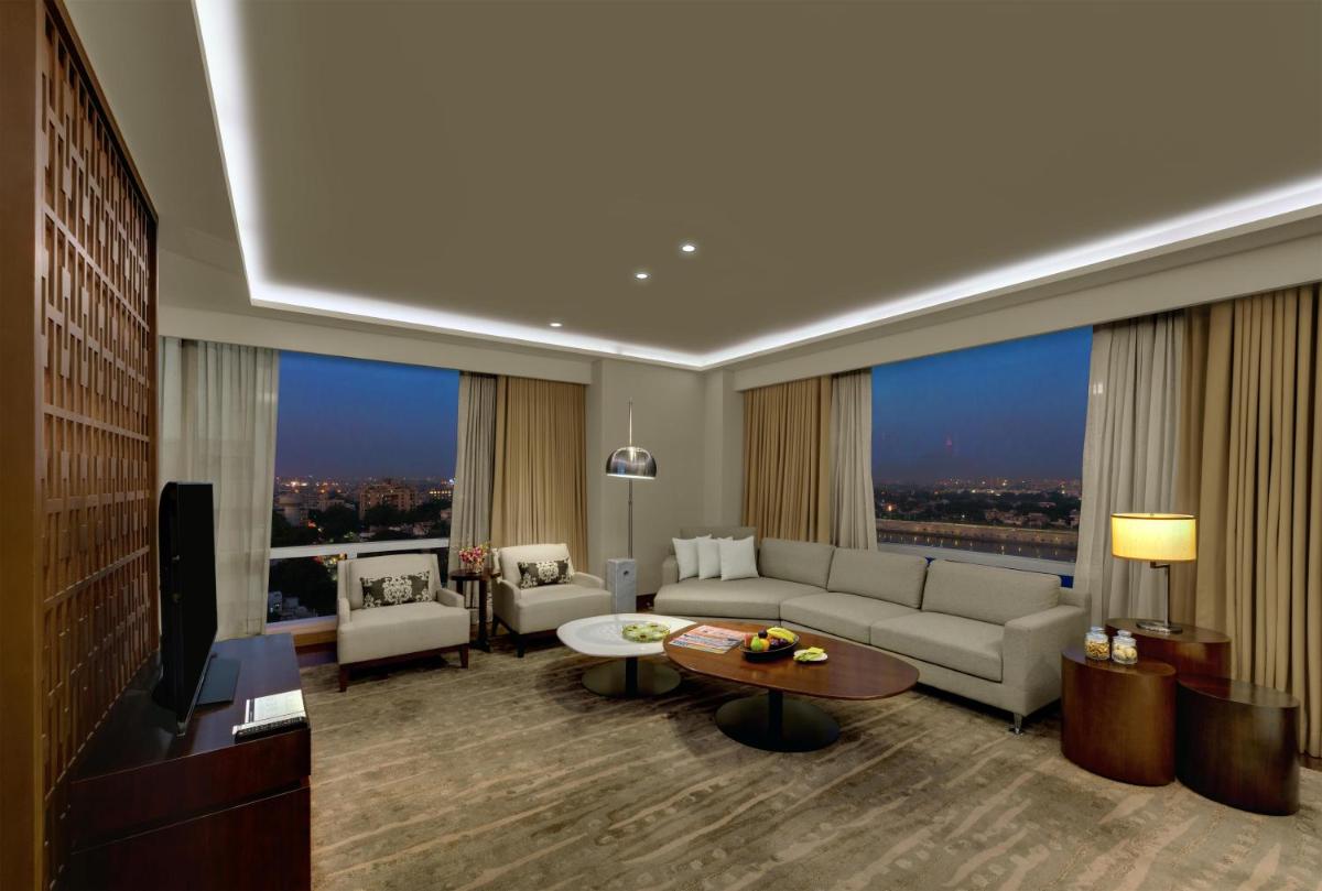 a living room with a couch and a tv at Hyatt Regency Ahmedabad in Ahmedabad