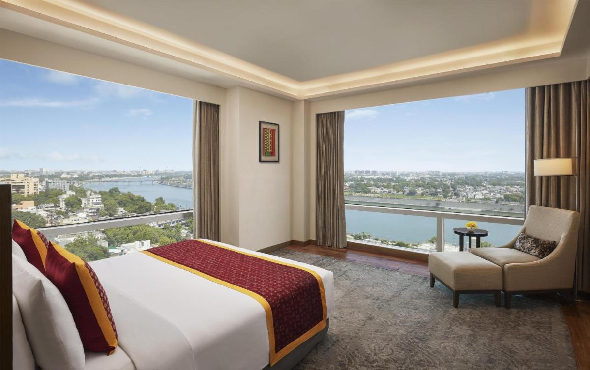a bedroom with a bed and a large window at Hyatt Regency Ahmedabad in Ahmedabad