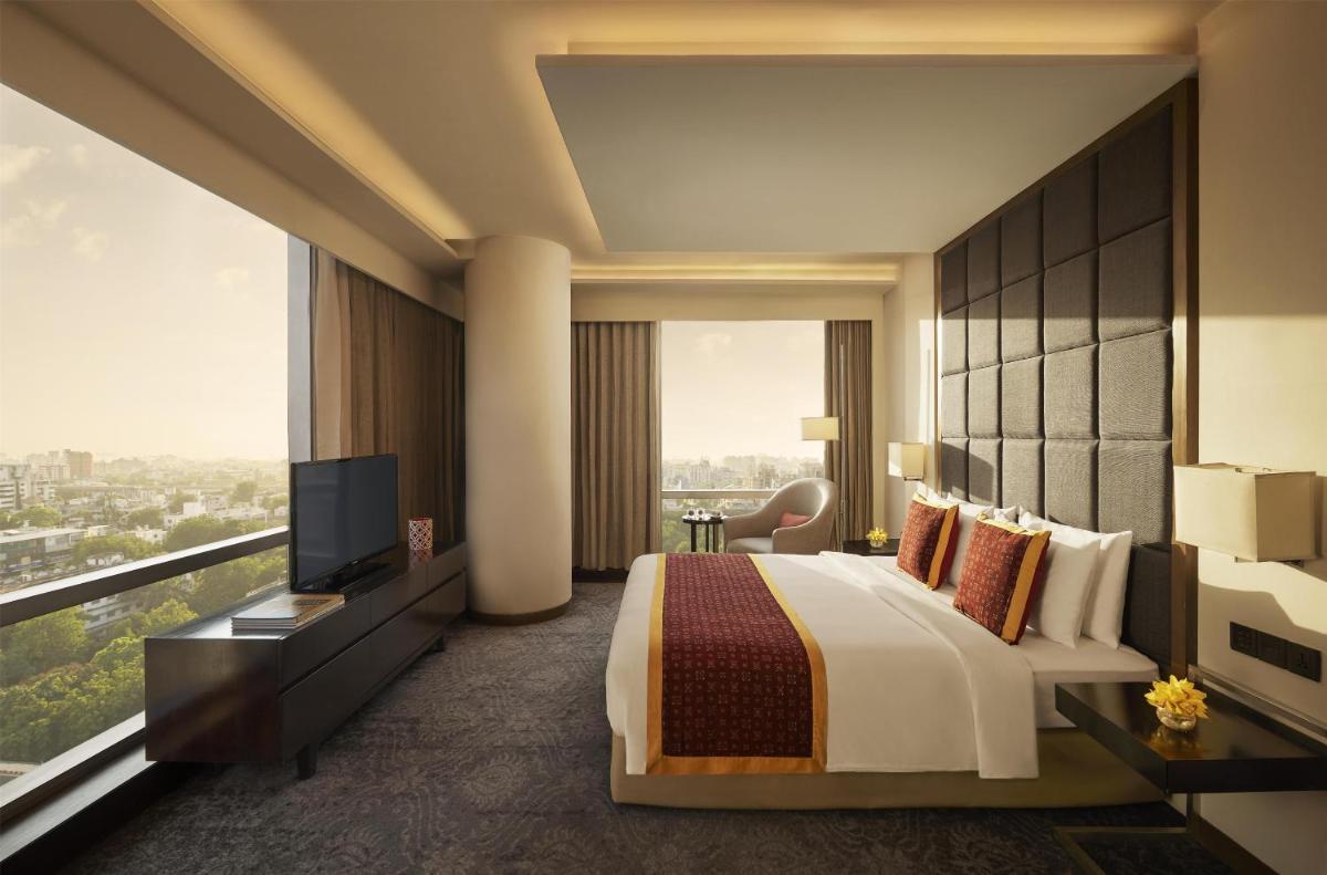 a hotel room with a bed and a television at Hyatt Regency Ahmedabad in Ahmedabad