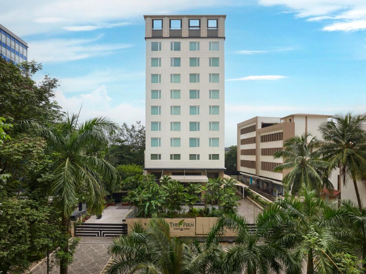 a tall white building with palm trees in front of it at The Fern Mumbai, Goregaon, Series by Marriott in Mumbai a tall white building with palm trees in front of it at The Fern Mumbai, Goregaon, Series by Marriott in Mumbai