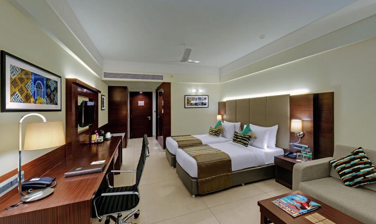 a hotel room with a bed and a desk at The Fern Kadamba Hotel And Spa in Old Goa +22 photos