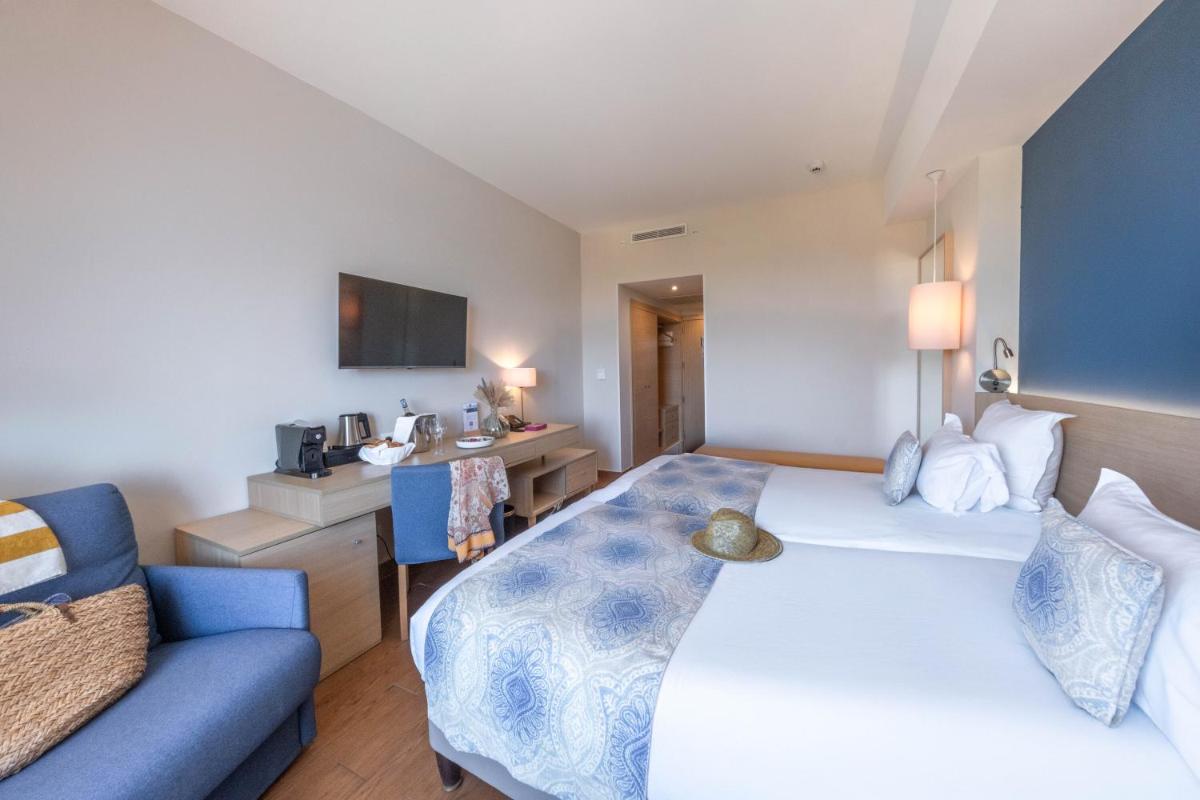 Un ou plusieurs lits dans un hébergement de l'établissement Hôtel Helios & SPA - Ile des Embiez