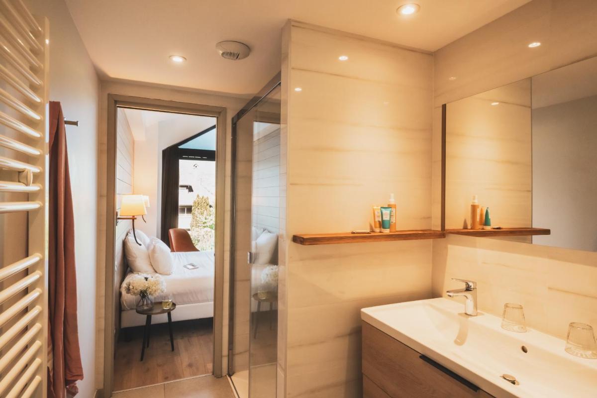 une salle de bains avec un lavabo et un miroir dans l'établissement Villa Caroline, Lac d'Annecy, à Duingt