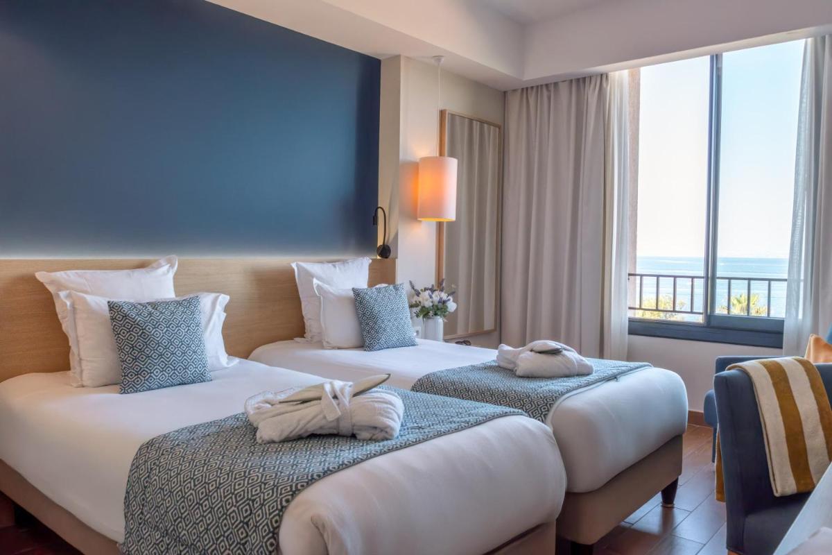 Un ou plusieurs lits dans un hébergement de l'établissement Hôtel Helios & SPA - Ile des Embiez