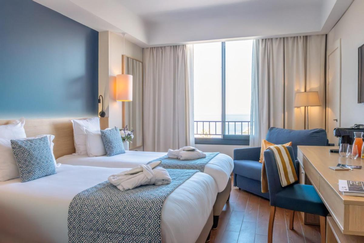 Un ou plusieurs lits dans un hébergement de l'établissement Hôtel Helios & SPA - Ile des Embiez