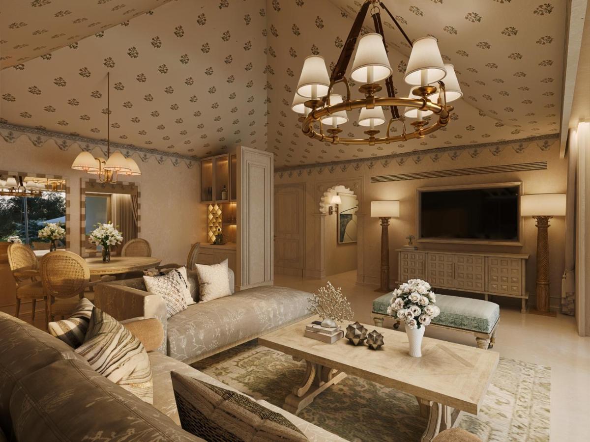 a living room with a couch and a table at Taj Aravali Resort & Spa Udaipur in Udaipur
