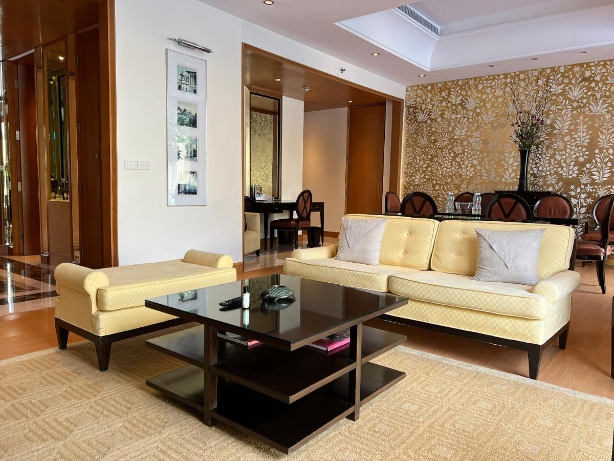 a living room with a couch and a table at Trident Gurgaon in Gurgaon