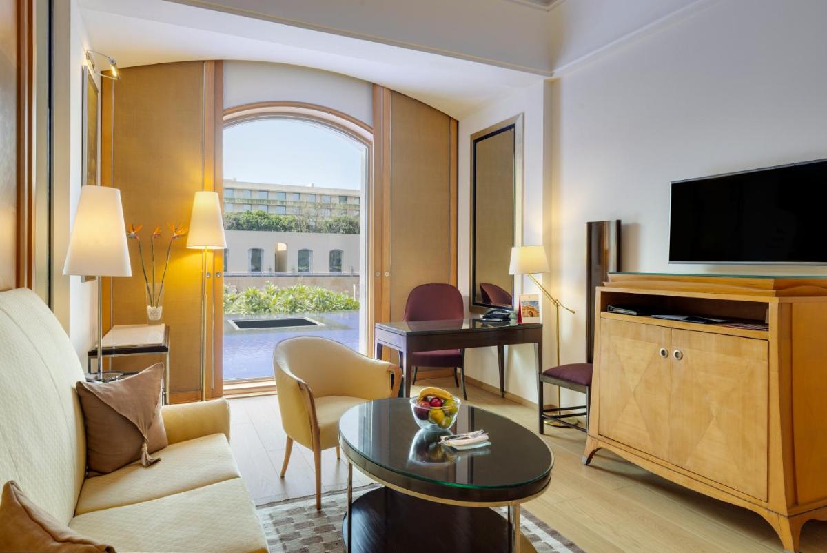 a living room with a large room with a television at Trident Gurgaon in Gurgaon