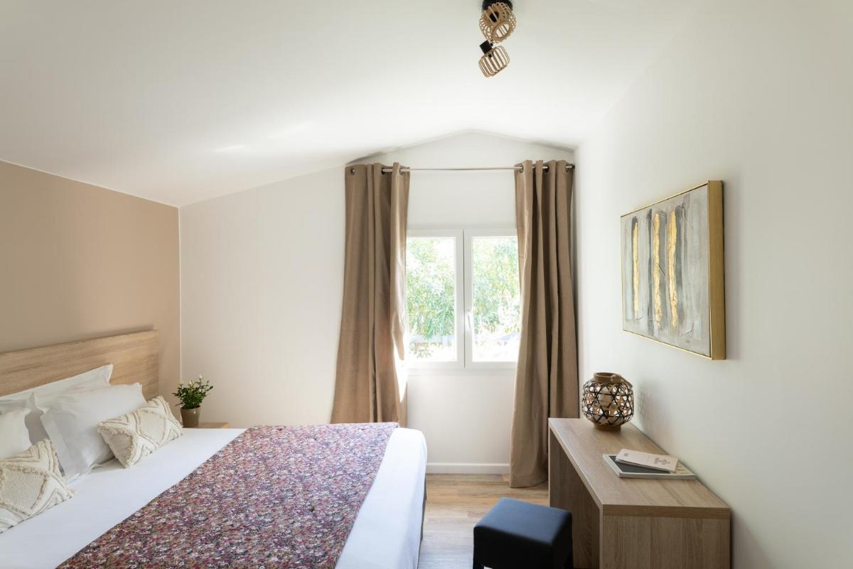 Un ou plusieurs lits dans un hébergement de l'établissement Golfe Hôtel & Spa Porto-Vecchio