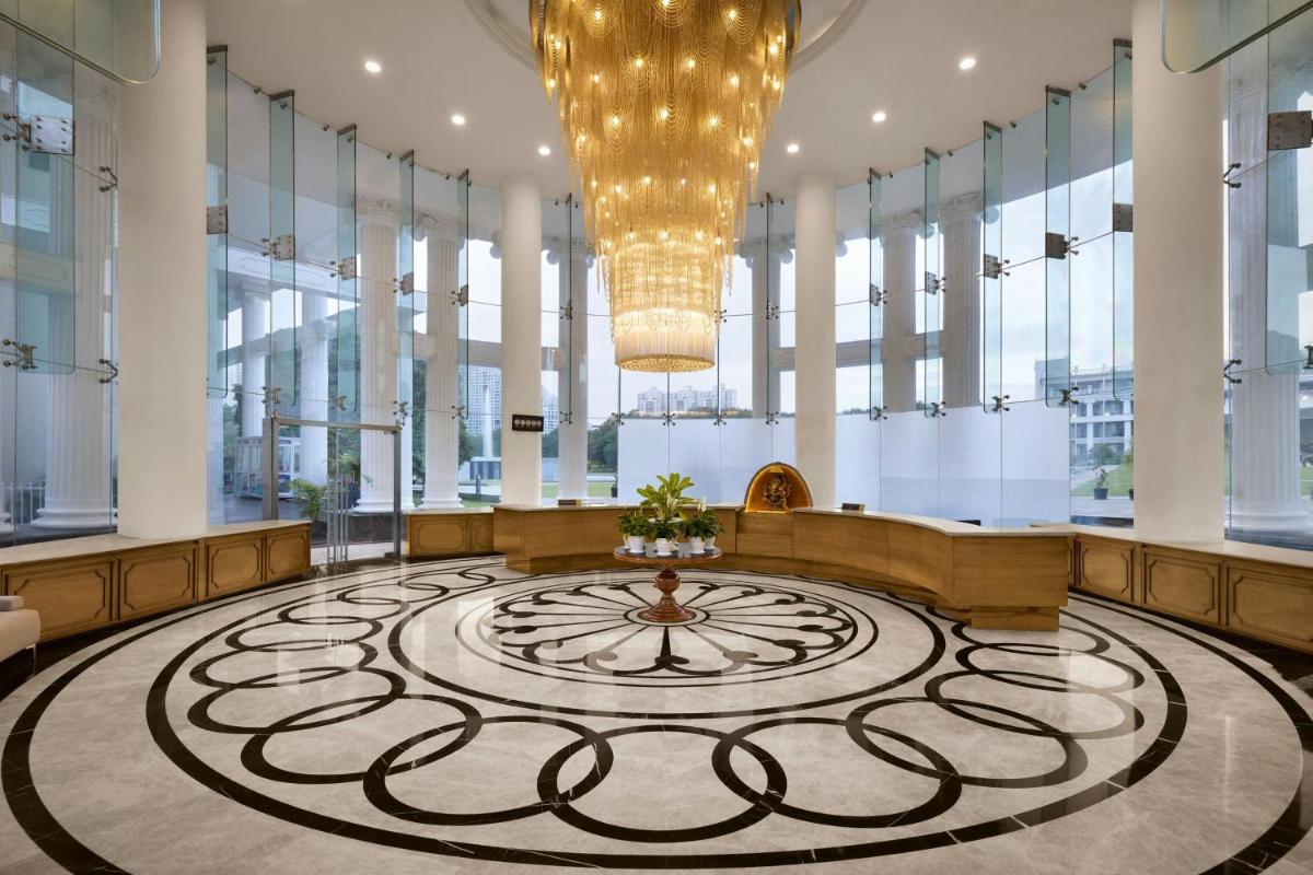 a large lobby with a large clock in the middle at Amanora The Fern Pune, Series by Marriott in Pune