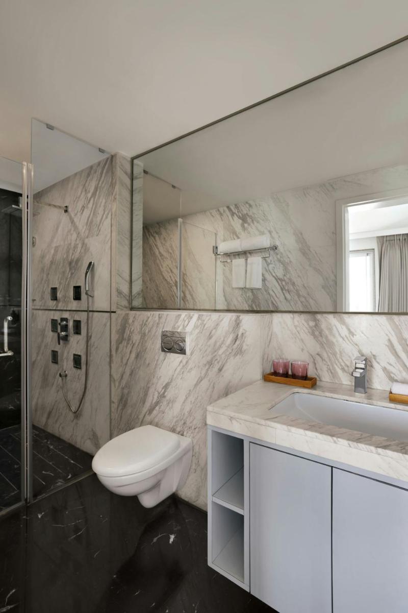 a bathroom with a toilet and a shower and a sink at Amanora The Fern Pune, Series by Marriott in Pune