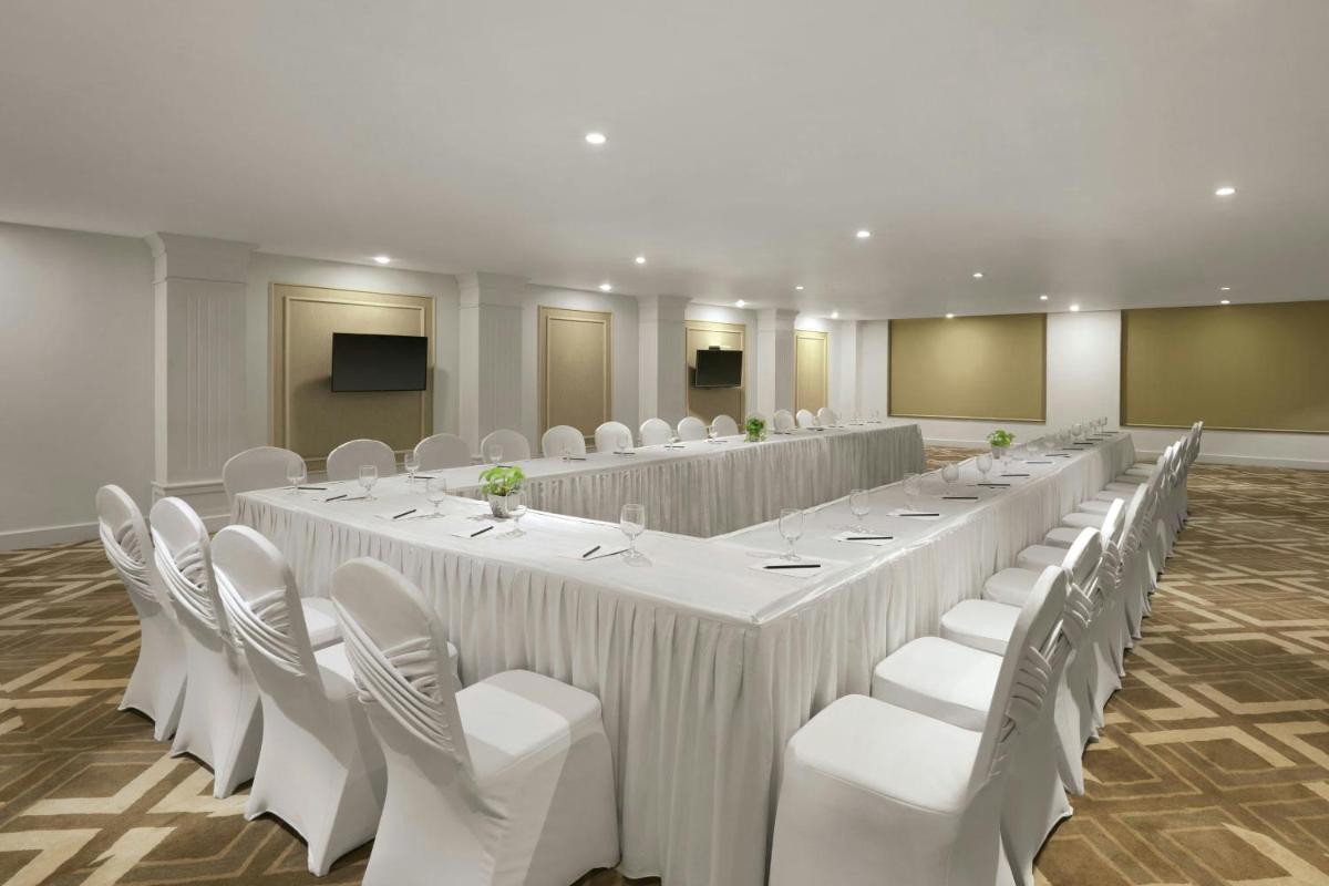 a conference room with a long table and white chairs at Amanora The Fern Pune, Series by Marriott in Pune