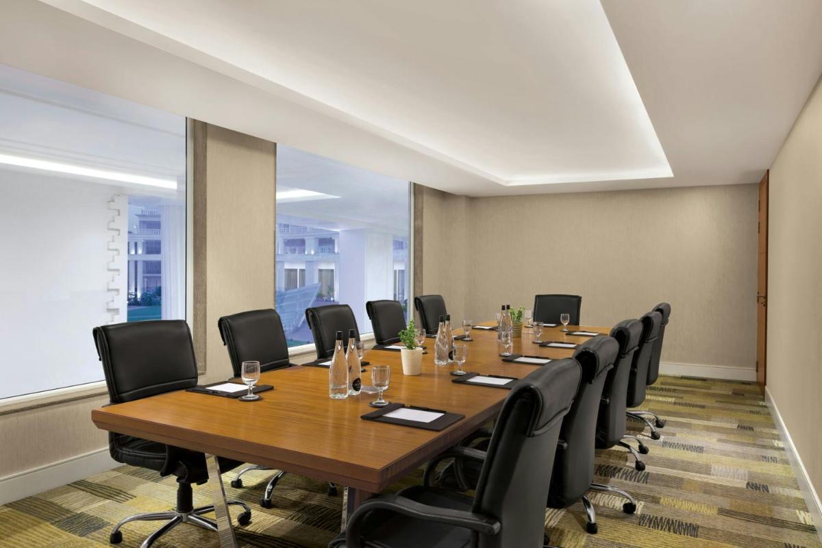 a conference room with a long table and chairs at Amanora The Fern Pune, Series by Marriott in Pune