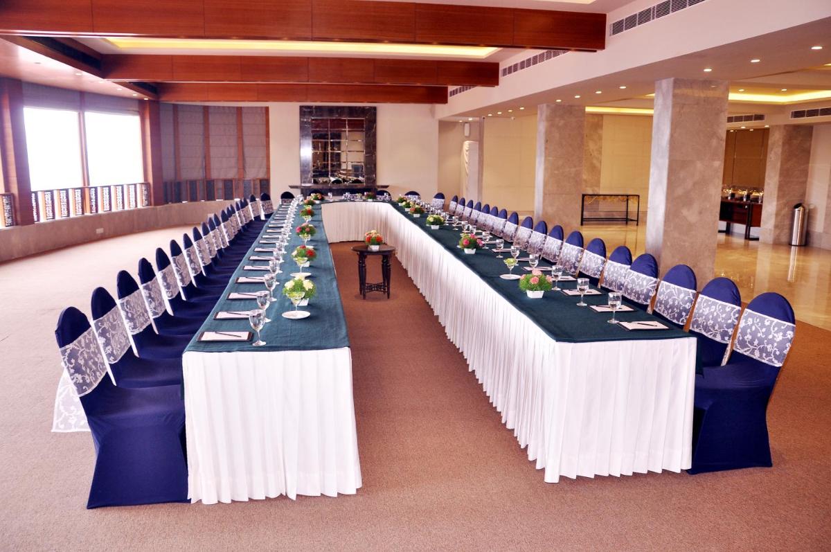 a row of long tables in a banquet hall at Radisson Hotel Shimla in Shimla