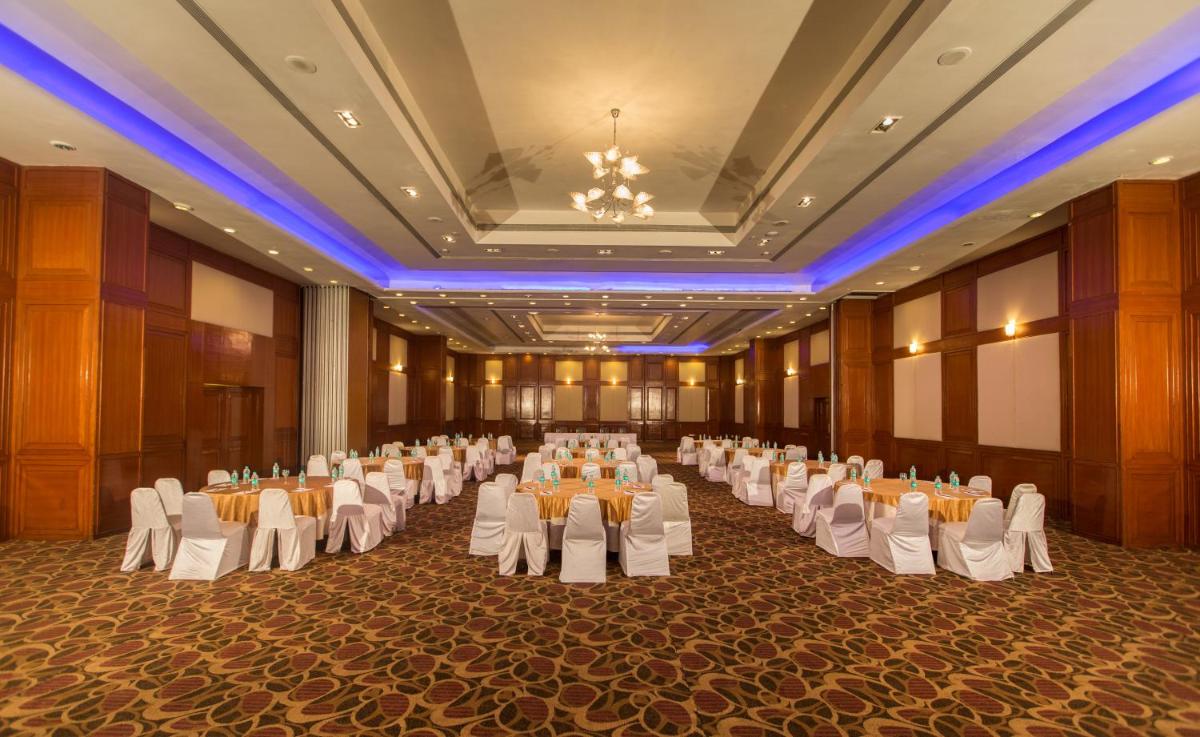 a large banquet hall with white chairs and tables at The Chancery Pavilion in Bengaluru
