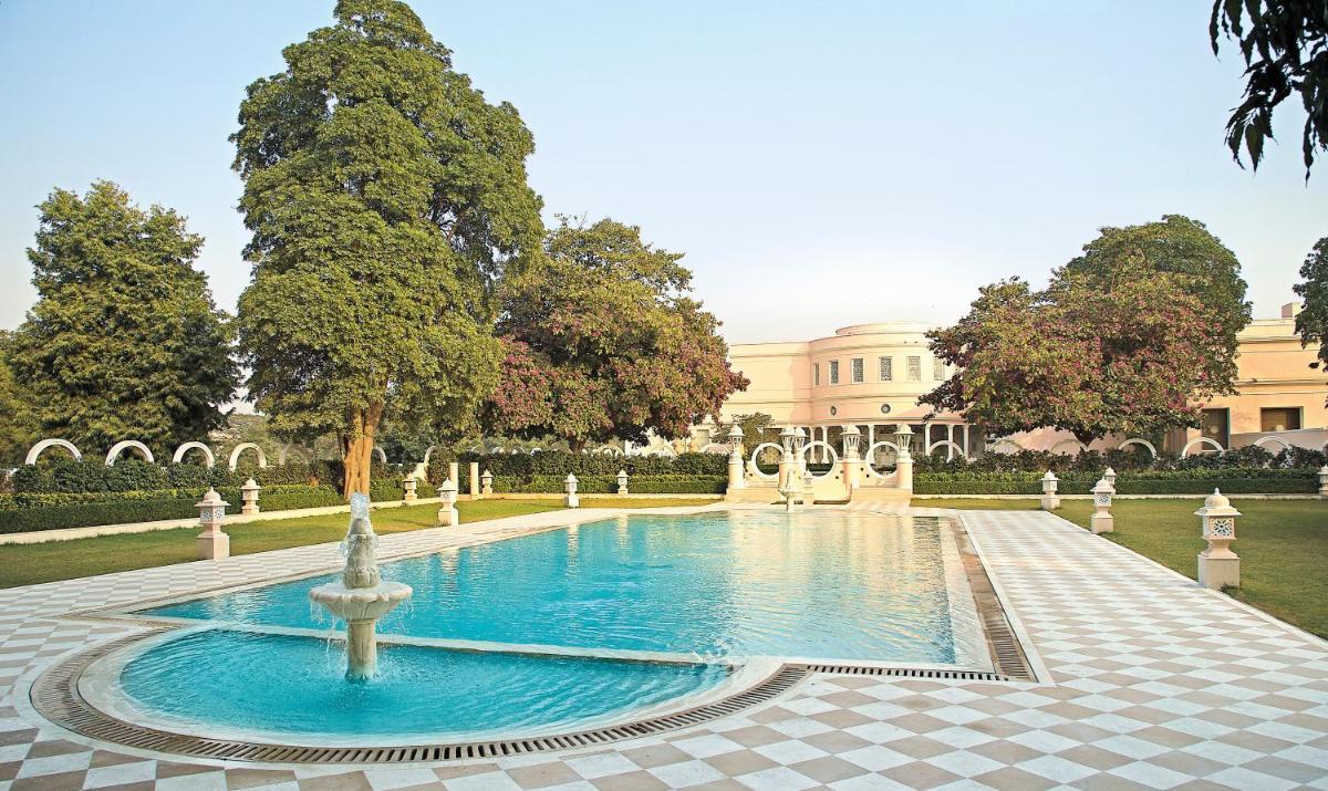 a fountain in a courtyard in front of a building at Rajmahal Palace RAAS in Jaipur