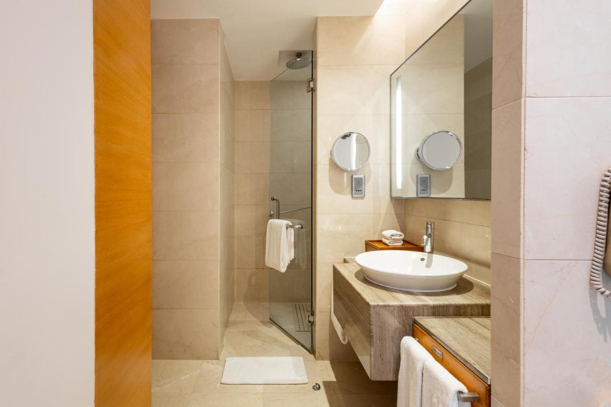 a bathroom with a sink and a mirror at Hyatt Pune in Pune