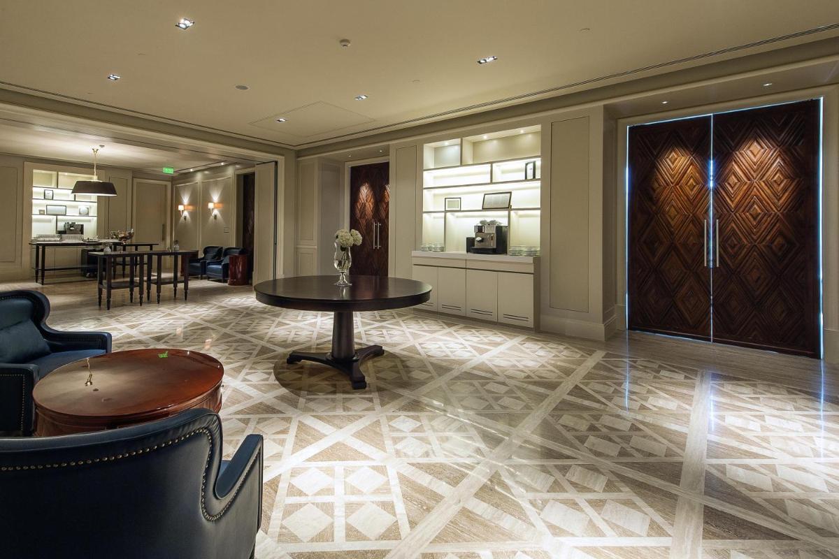 a living room with a table and a kitchen at Park Hyatt Chennai in Chennai