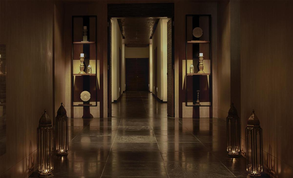 a hallway of a building with a long hall with clocks at Park Hyatt Chennai in Chennai