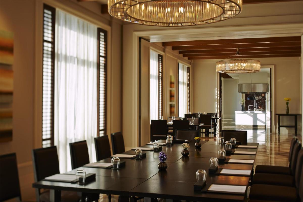 a large meeting room with a long table and chairs at Park Hyatt Chennai in Chennai