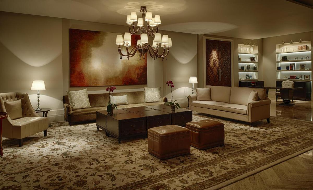 a living room with couches and a chandelier at Park Hyatt Chennai in Chennai