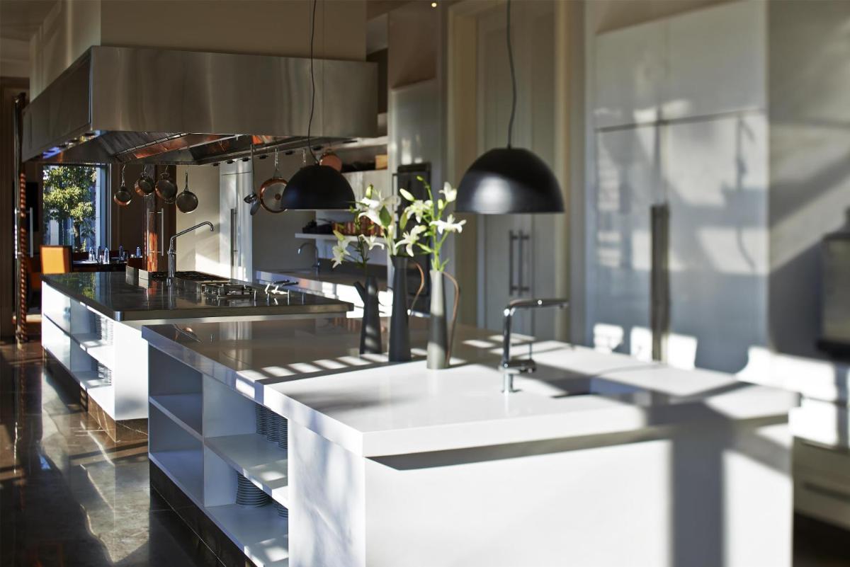 a large kitchen with white counters and sinks at Park Hyatt Chennai in Chennai