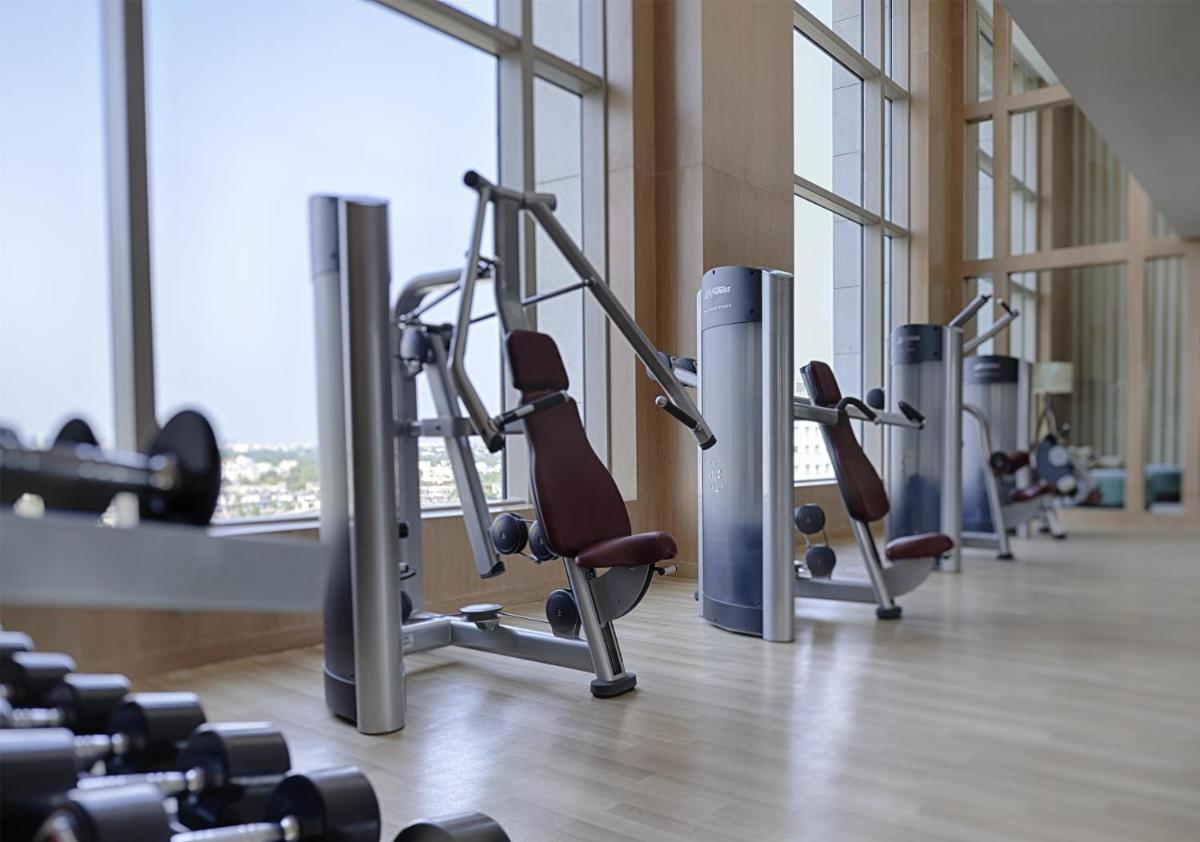 a gym with several rows of tread machines at Park Hyatt Chennai in Chennai