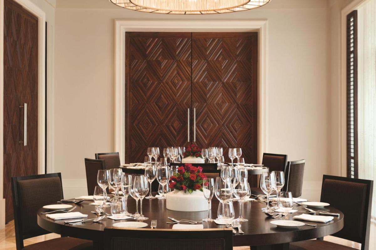a dining room with a table with wine glasses at Park Hyatt Chennai in Chennai