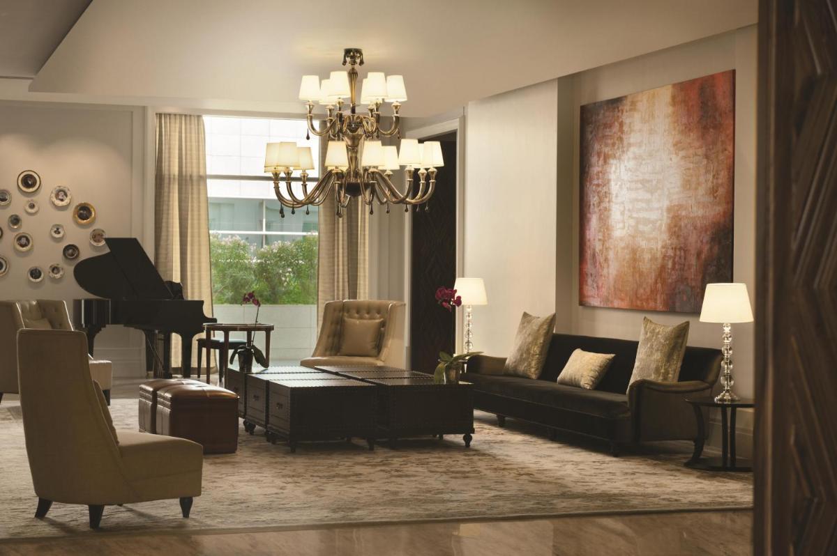 a living room with a couch and a piano at Park Hyatt Chennai in Chennai