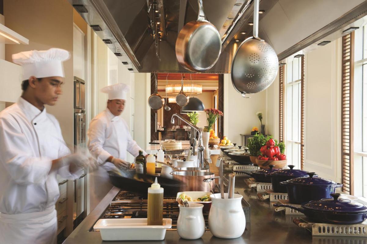 two chefs preparing food in a restaurant kitchen at Park Hyatt Chennai in Chennai