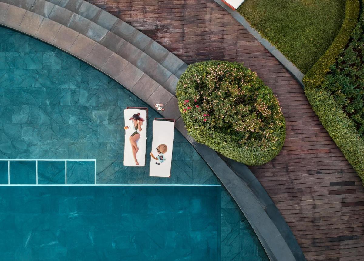 an overhead view of a swimming pool with two people at Park Hyatt Chennai in Chennai