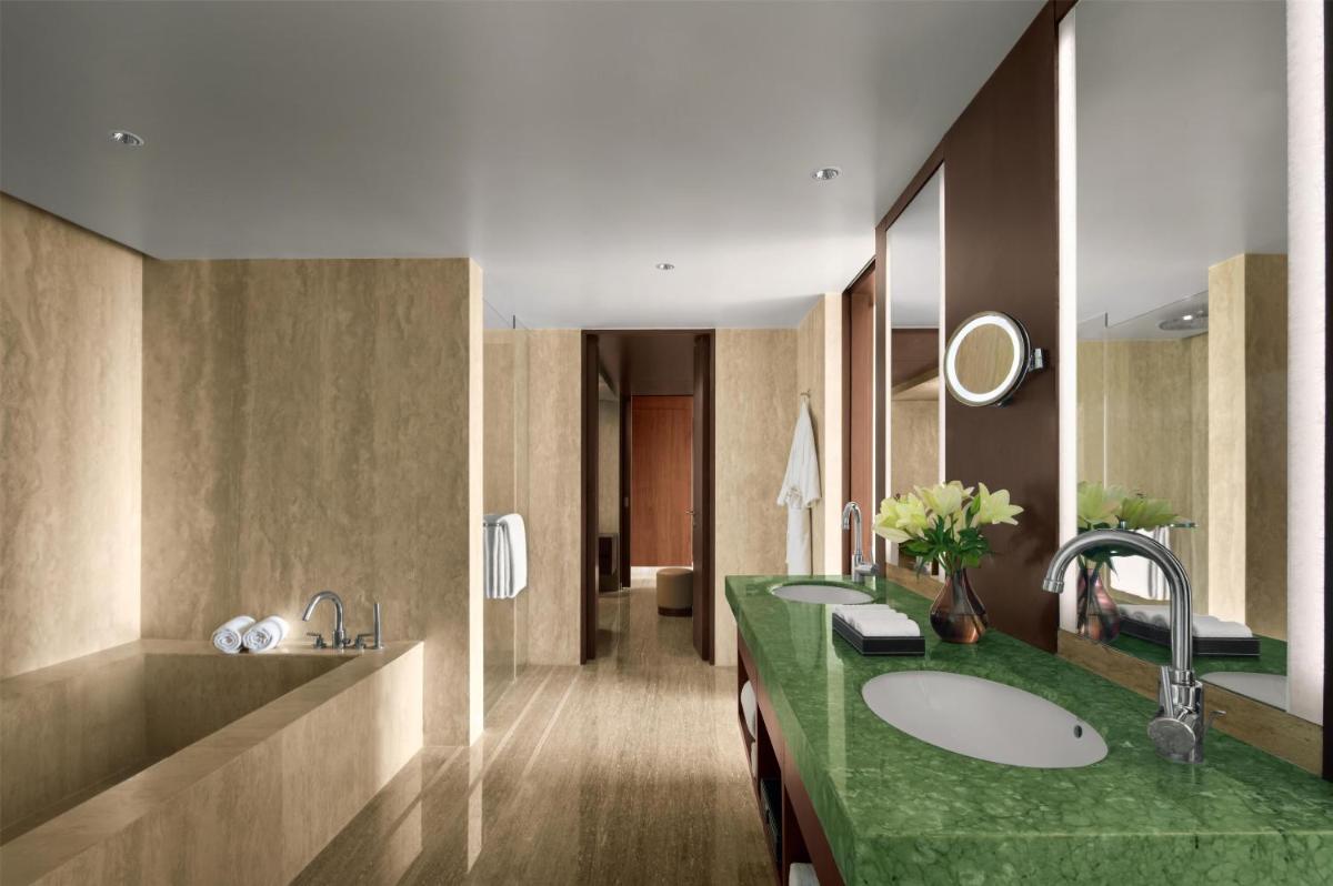 a bathroom with two sinks and a green counter at Park Hyatt Chennai in Chennai