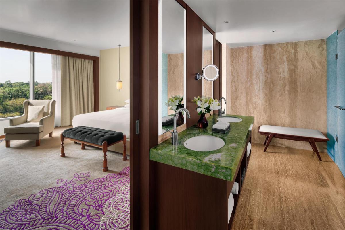 a hotel room with a bed and a bathroom at Park Hyatt Chennai in Chennai