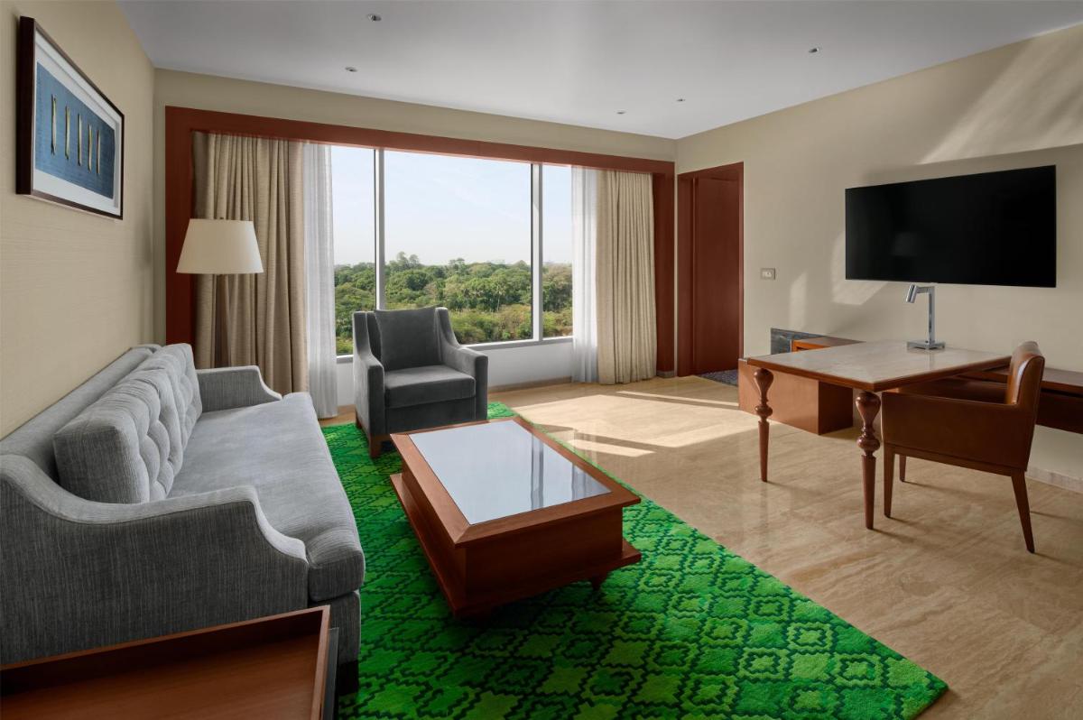 a living room with a couch and a television at Park Hyatt Chennai in Chennai