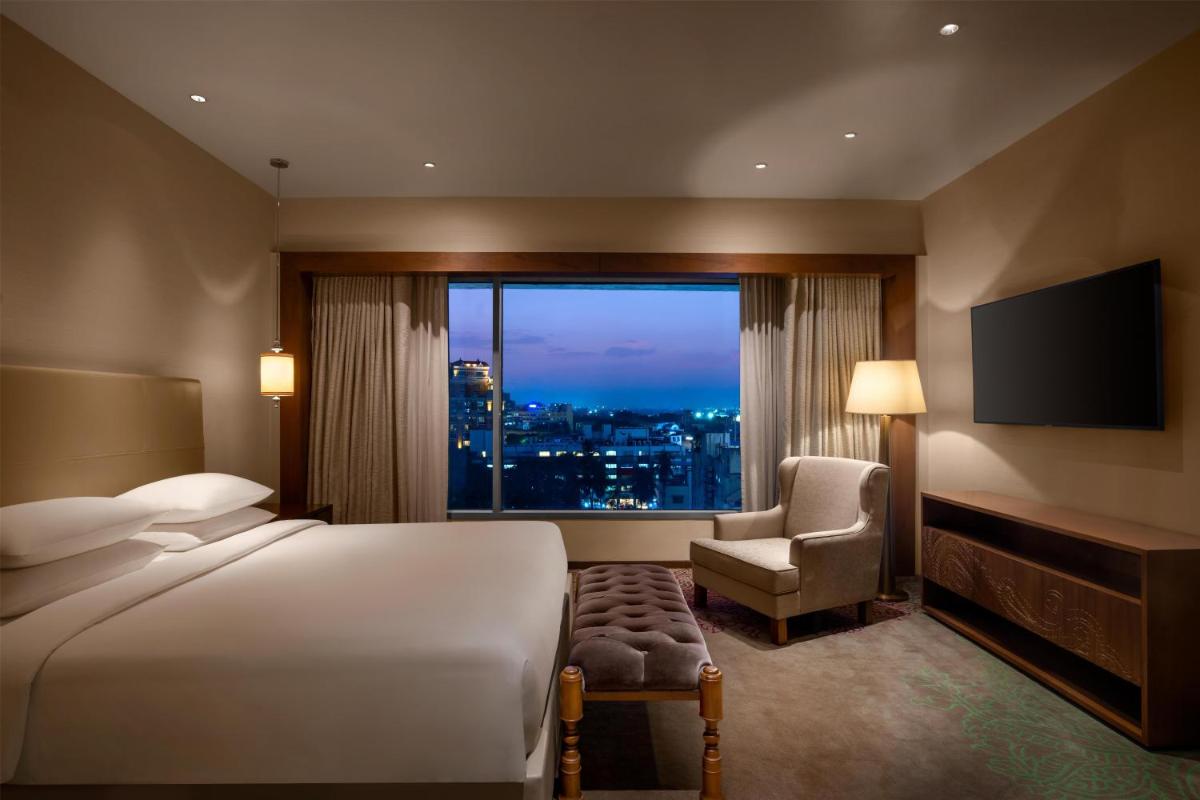 a hotel room with a bed and a window at Park Hyatt Chennai in Chennai