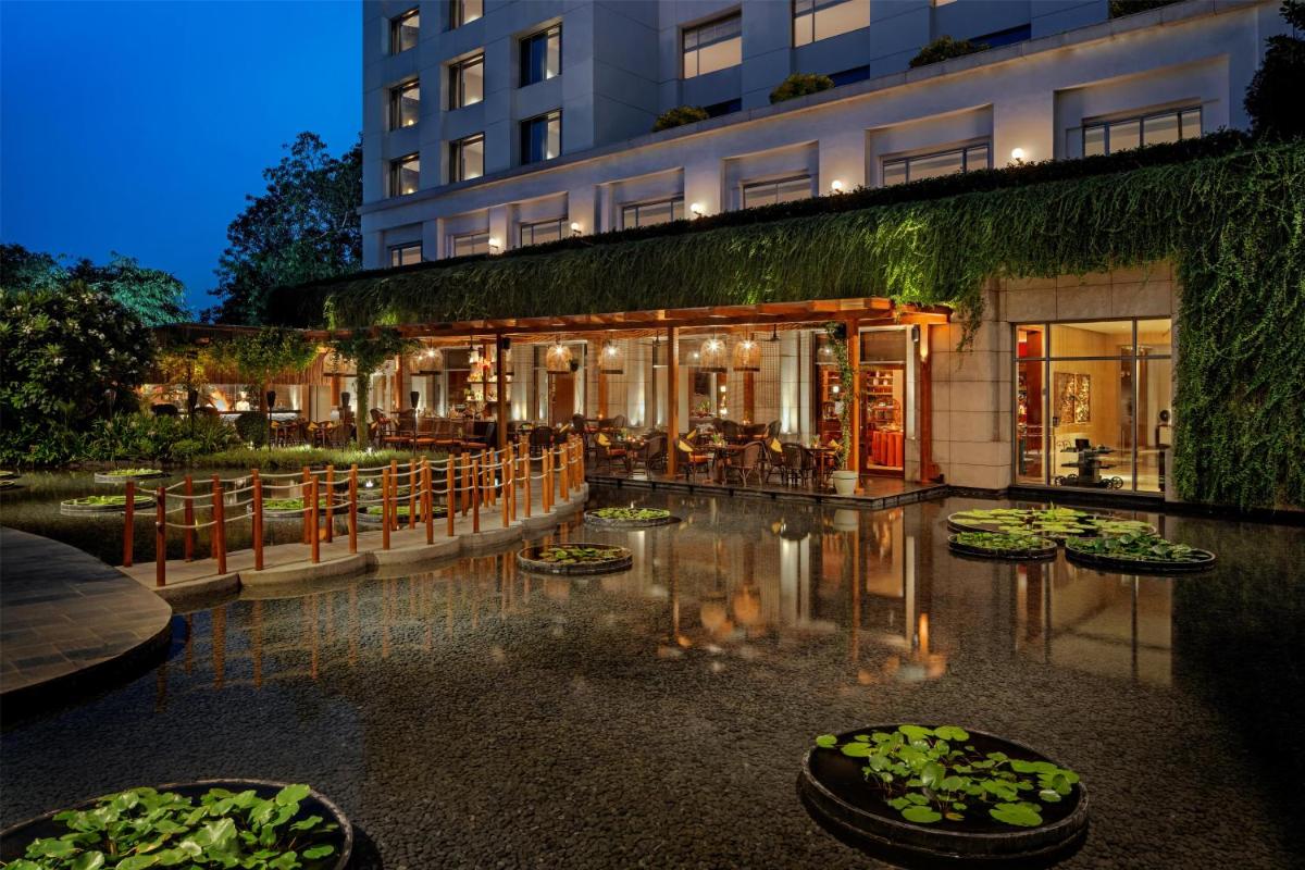 a hotel with lily pads on the ground in front of a building at Park Hyatt Chennai in Chennai