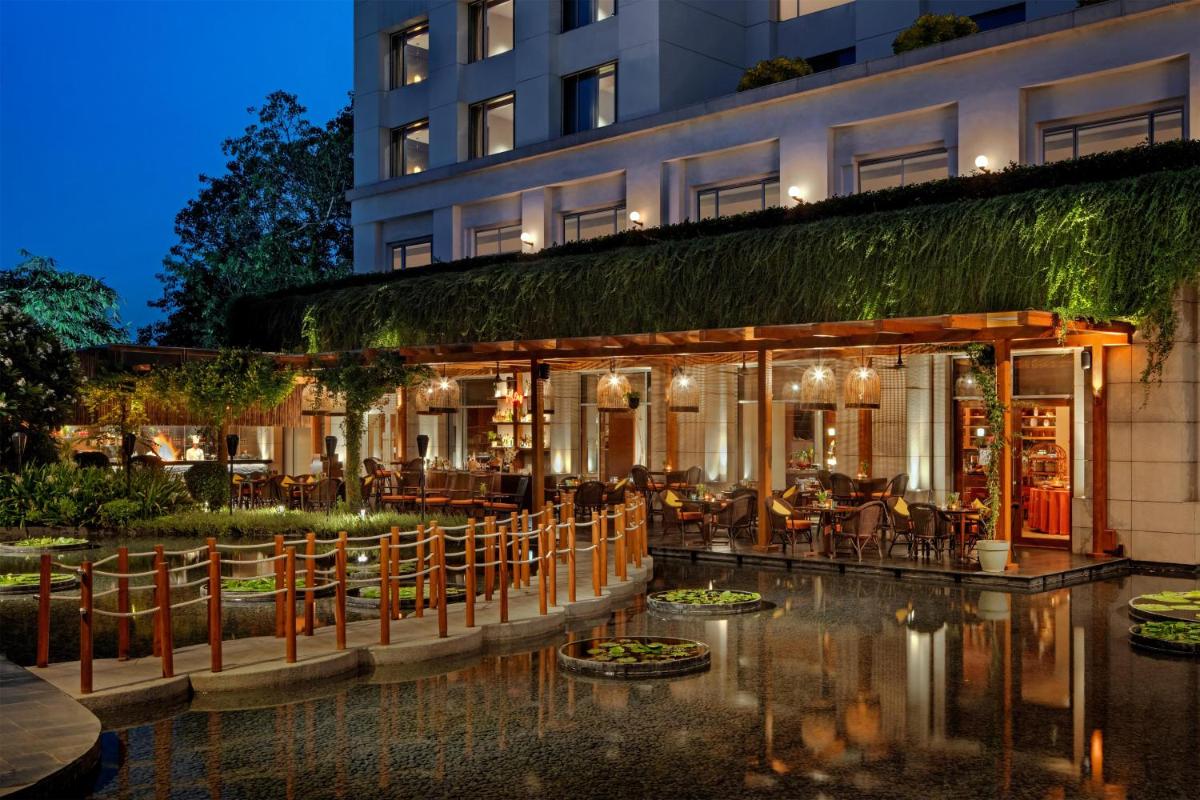a restaurant with tables and chairs in front of a building at Park Hyatt Chennai in Chennai
