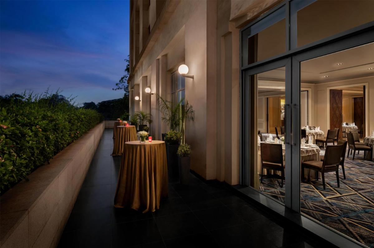 a restaurant with two tables on the side of a building at Park Hyatt Chennai in Chennai