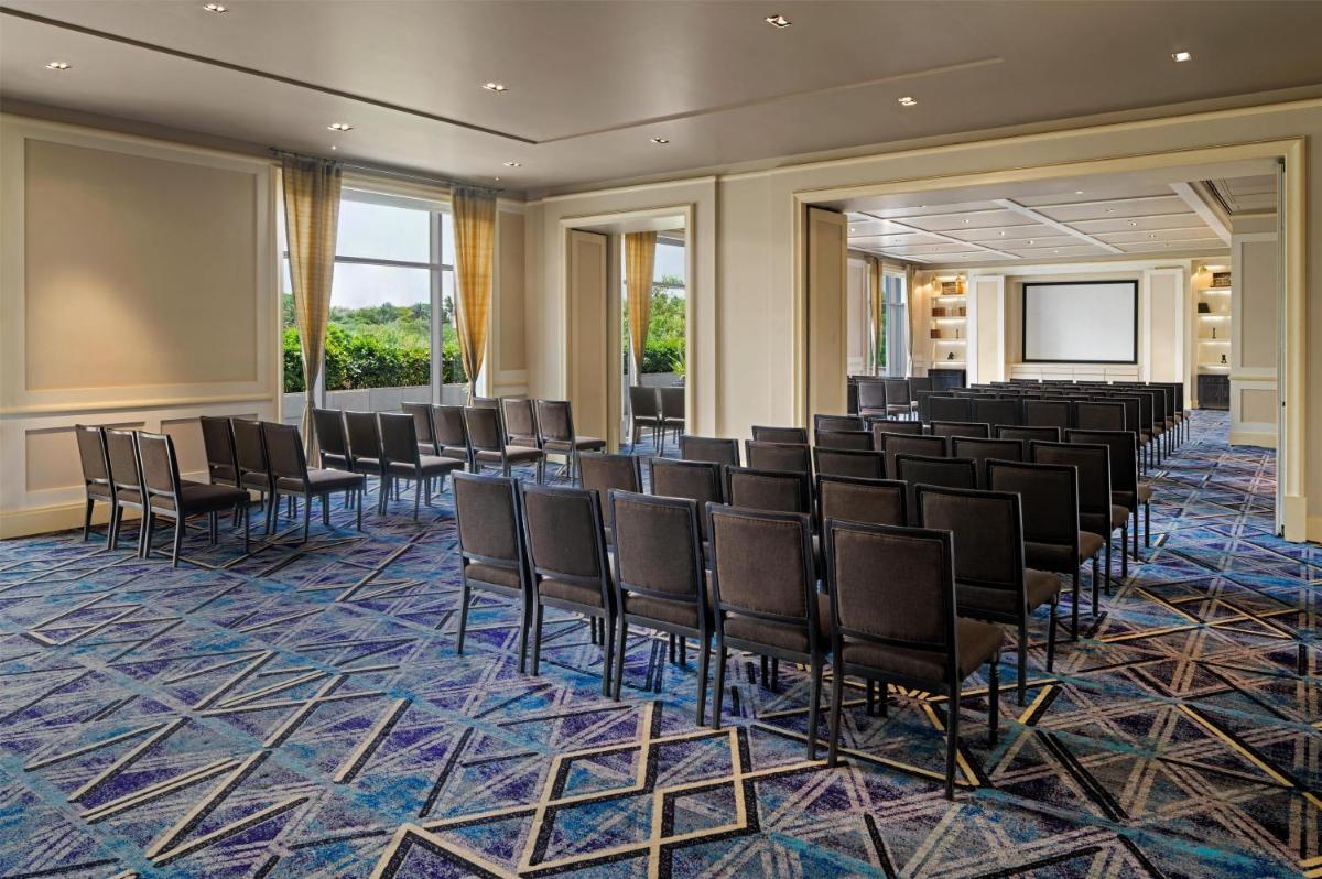 a conference room with chairs and a projection screen at Park Hyatt Chennai in Chennai +174 photos