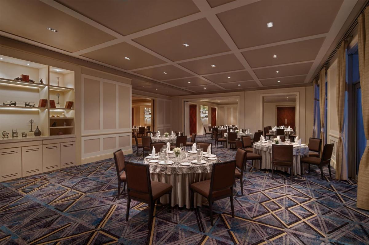 a dining room with tables and chairs in a room at Park Hyatt Chennai in Chennai