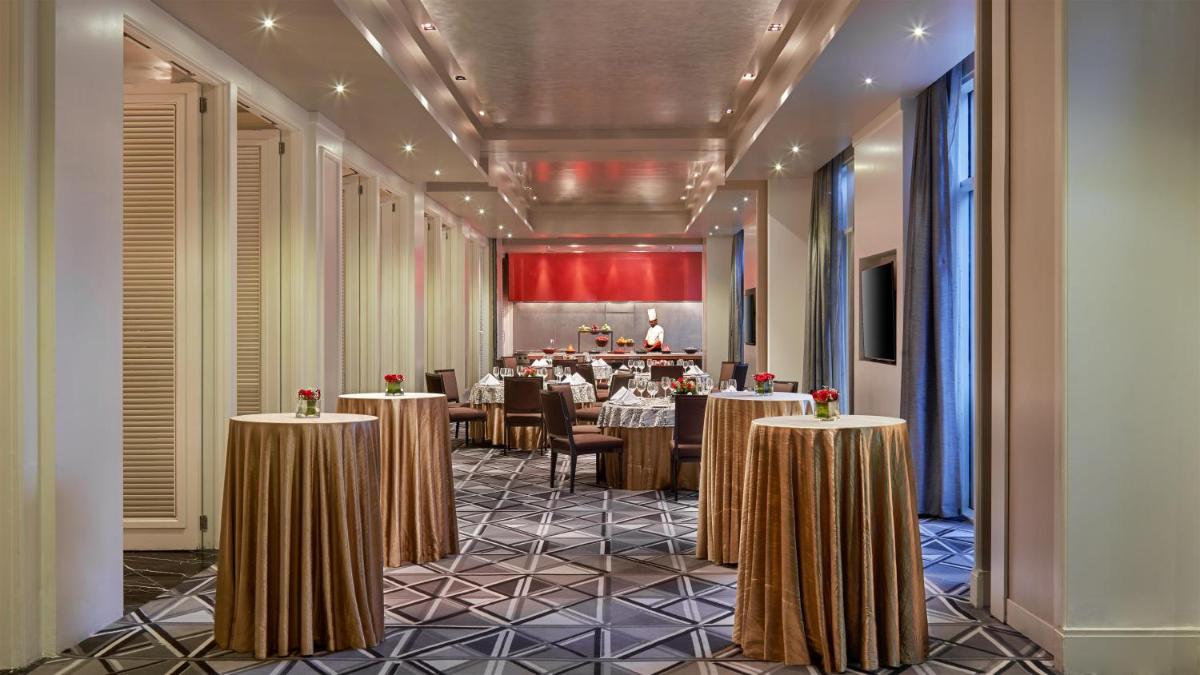 a banquet hall with tables and chairs in a room at Park Hyatt Chennai in Chennai