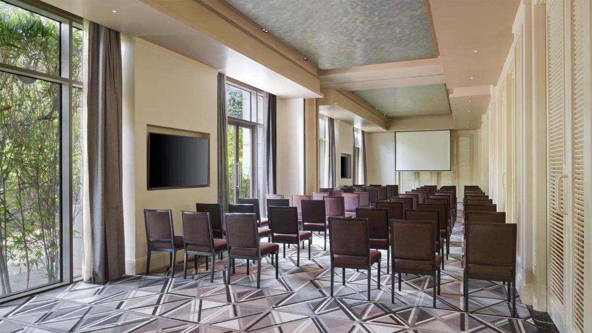 a conference room with chairs and a flat screen tv at Park Hyatt Chennai in Chennai