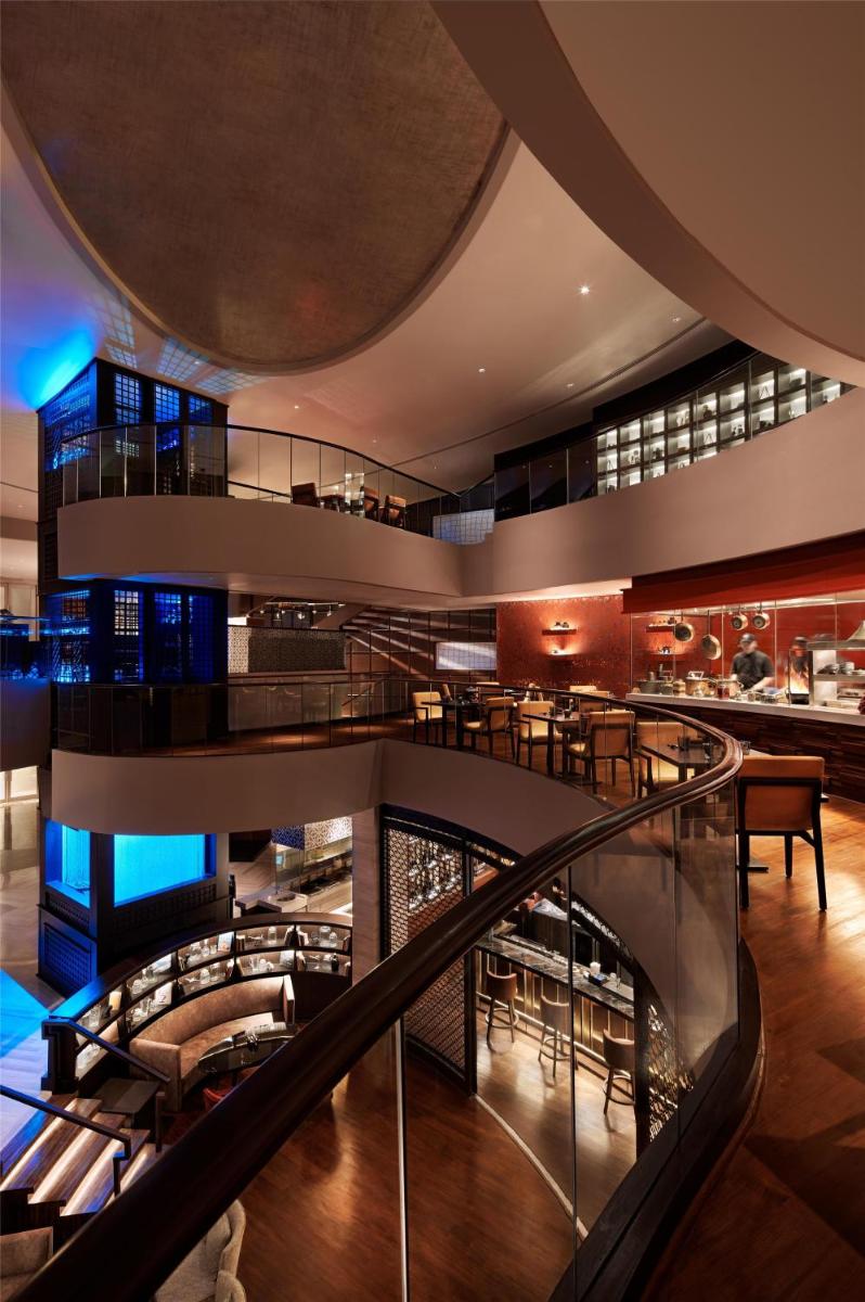 a spiral staircase in a building with a restaurant at Park Hyatt Chennai in Chennai