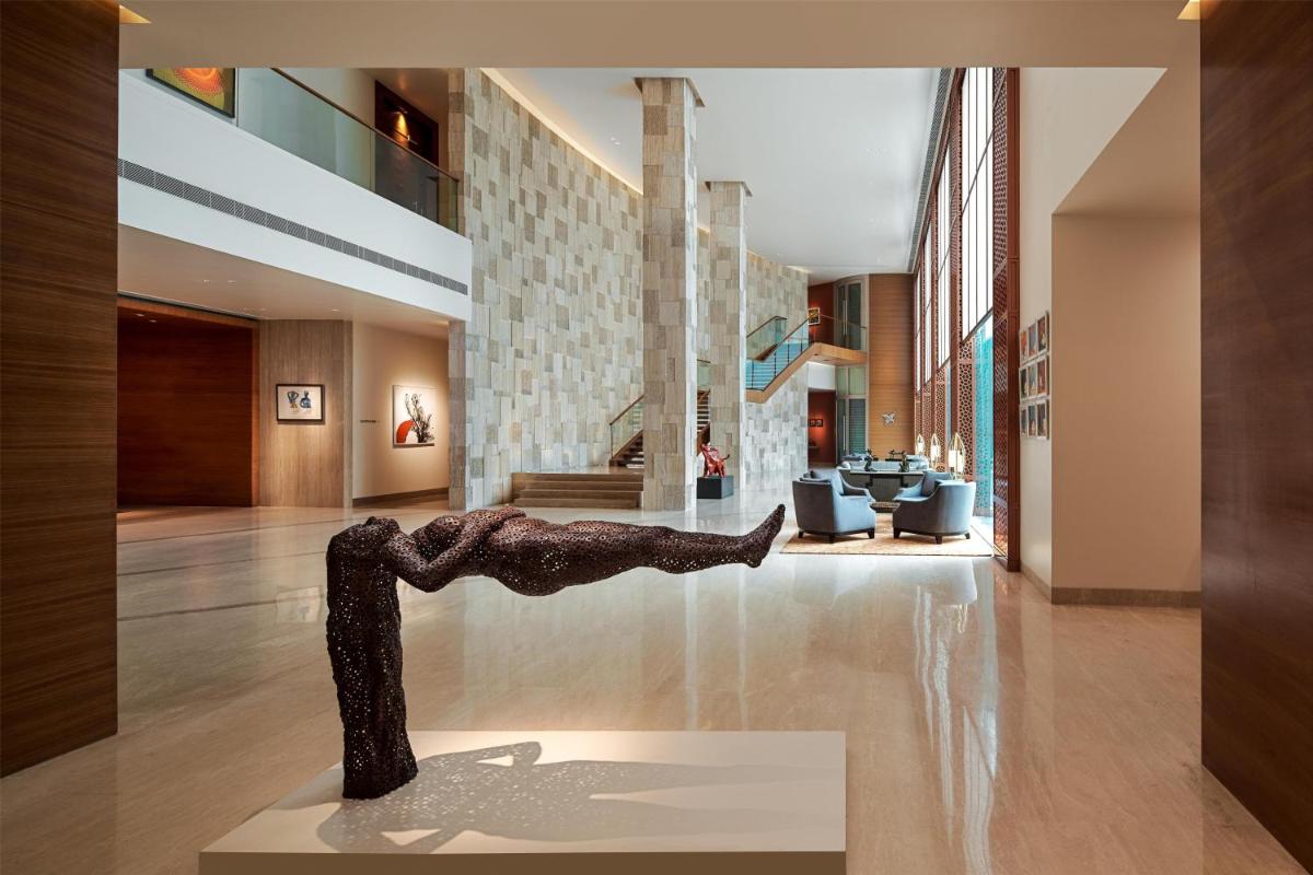 a statue of a person doing a handstand in a lobby at Park Hyatt Chennai in Chennai