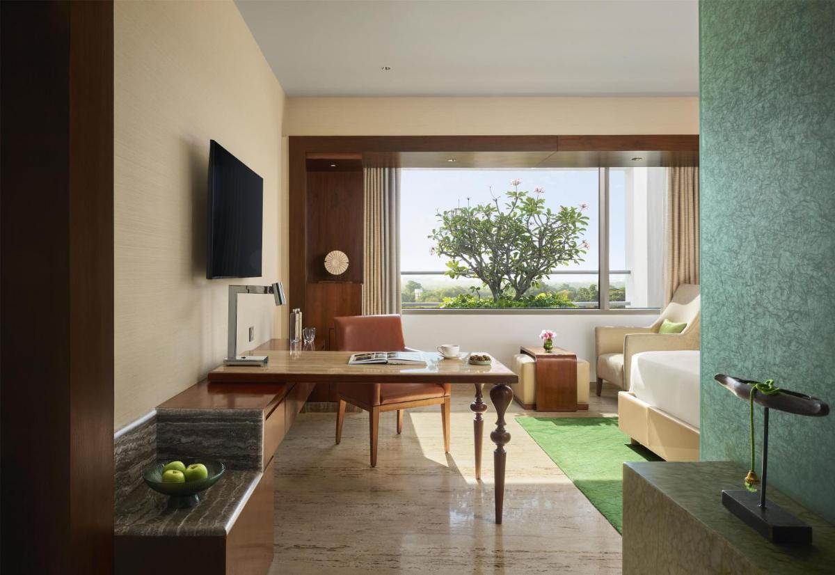 a living room with a table and a couch at Park Hyatt Chennai in Chennai
