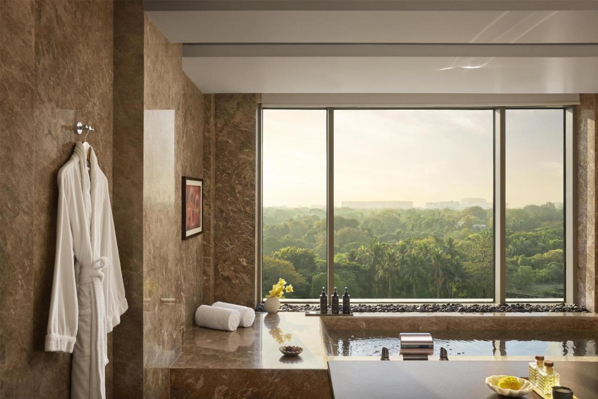 a bathroom with a tub and a large window at Park Hyatt Chennai in Chennai