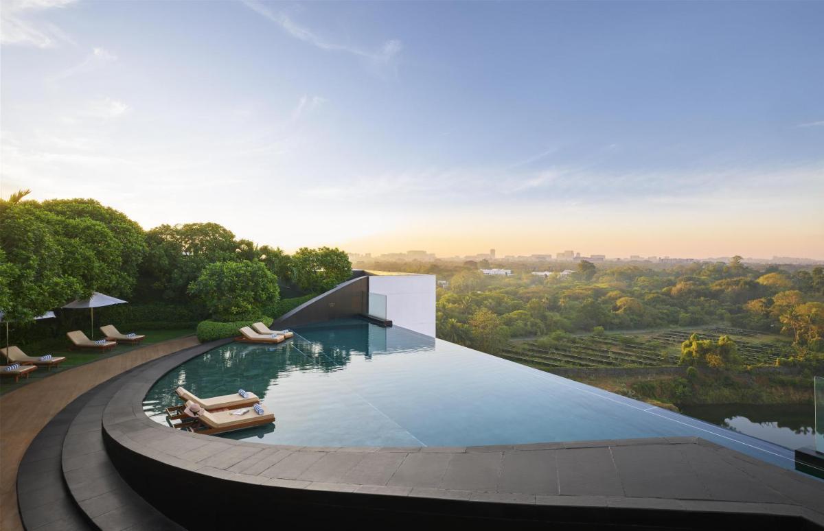 a infinity pool with a view of a city at Park Hyatt Chennai in Chennai