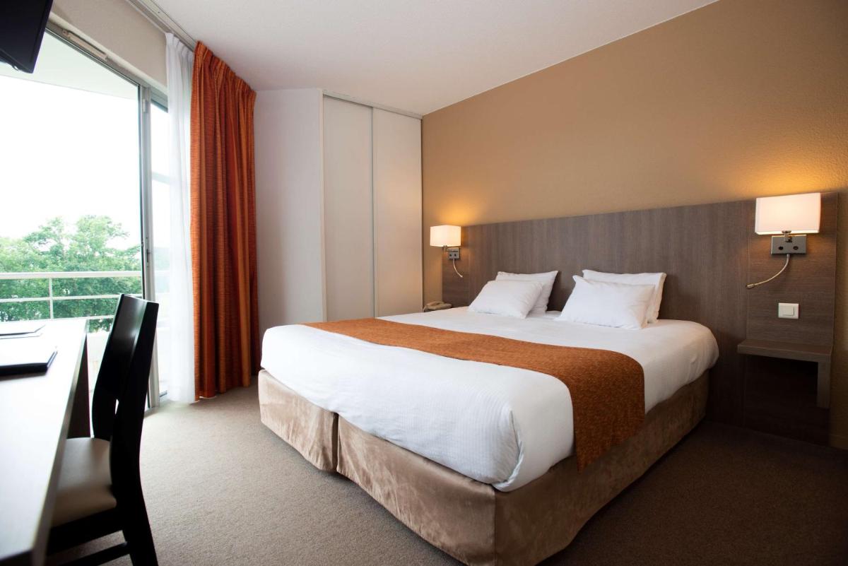 Un ou plusieurs lits dans un hébergement de l'établissement Best Western Hotel Sourcéo
