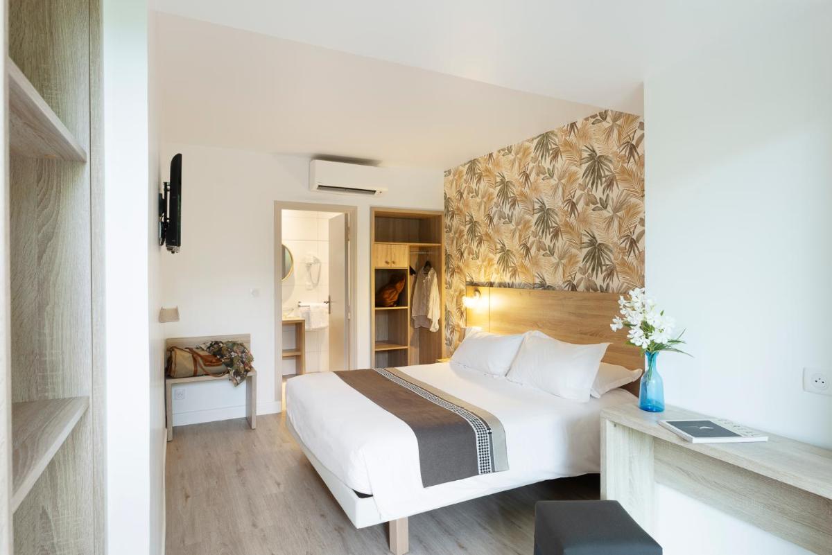 Un ou plusieurs lits dans un hébergement de l'établissement Golfe Hôtel & Spa Porto-Vecchio